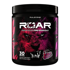 A black Rule One R1 Roar Ferocious Pre-Workout container features a bold purple and pink lion face, offers 30 servings of wild grape flavor, and is designed to boost workout intensity as a powerful training supplement.